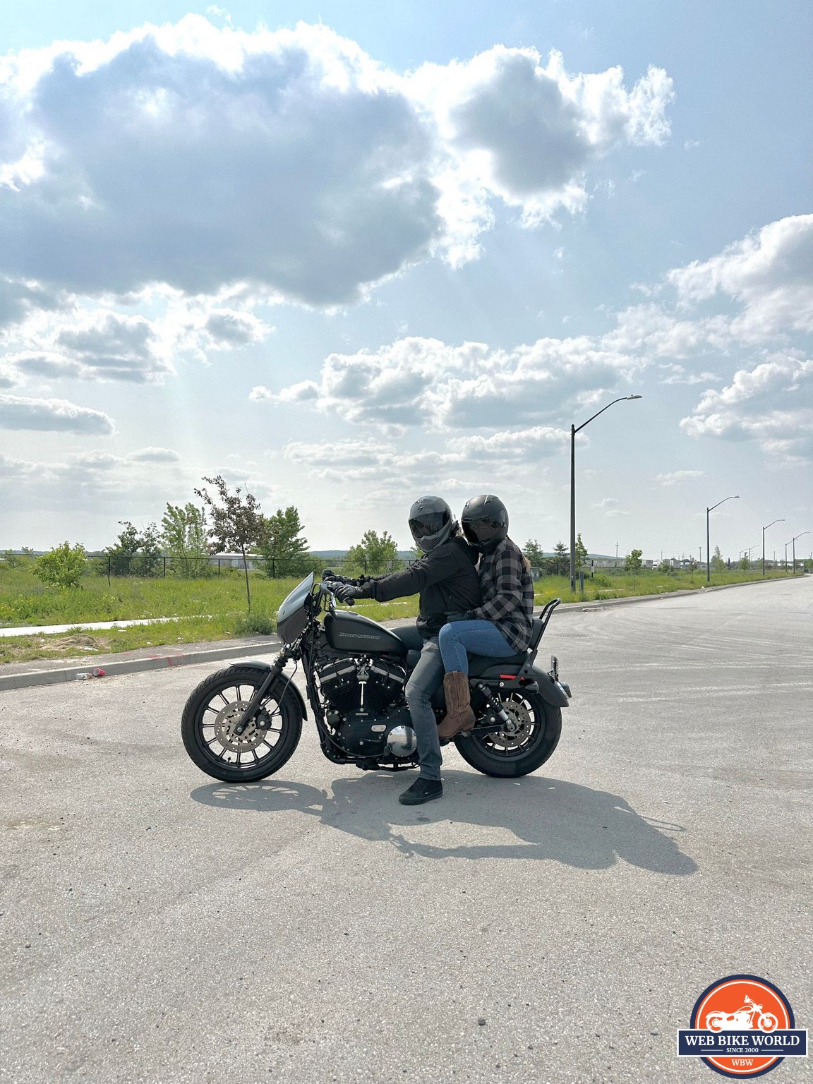 Two riders sitting on a Harley Davidson Iron 883