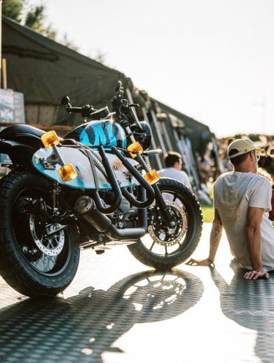 a motorcycle and visitors at the 2023 Wheels & Waves Bike Show in Biarritz, France