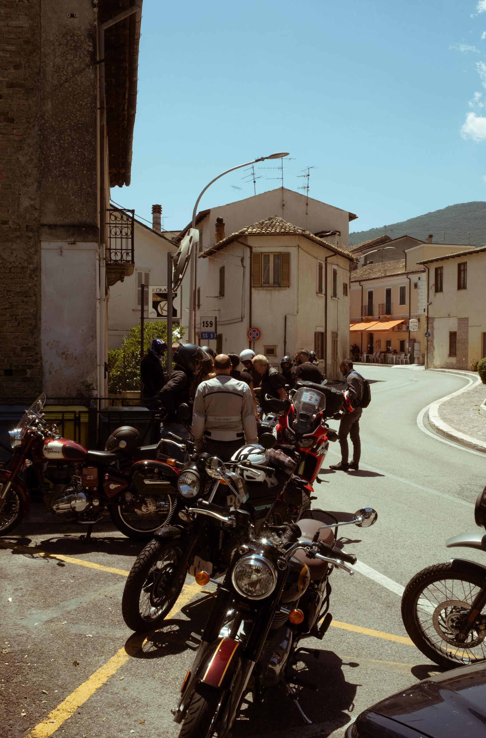 Motorcyclists stop for a break in a Medieval town in Abruzzo, Italy