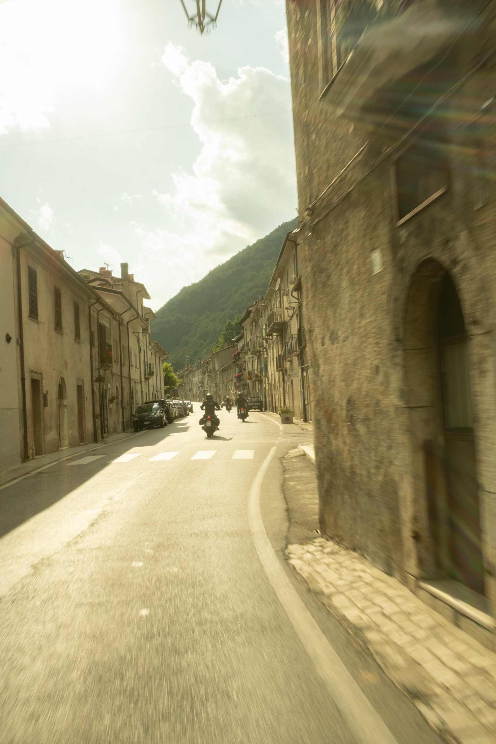 Motorcyclists ride through a mediveal town in Abruzzo, Italy