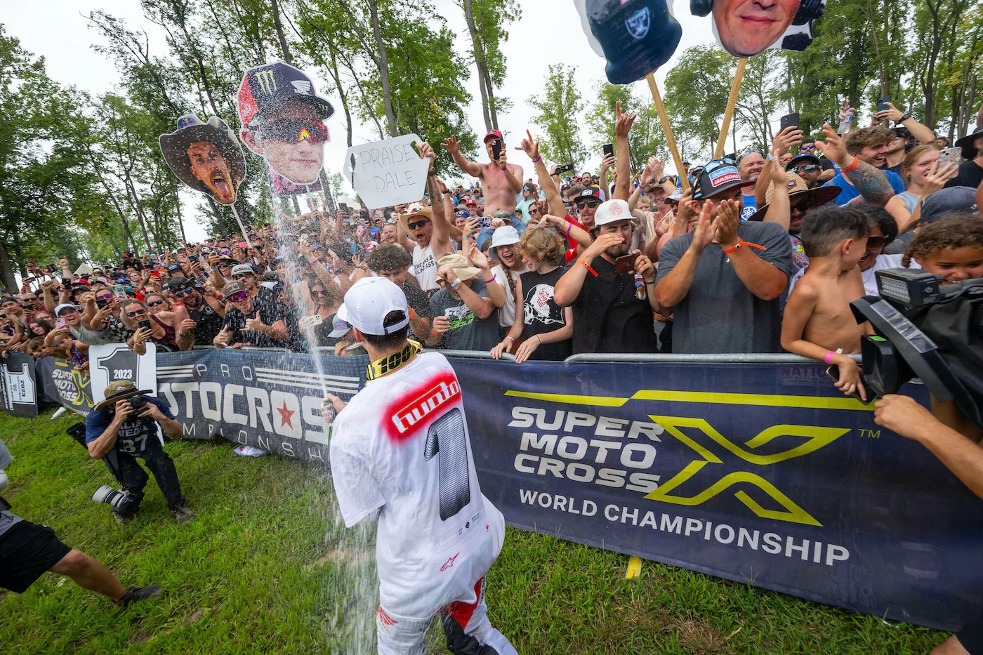 Rider sprays champagne on an MX crowd. Media provided by Pro MX.