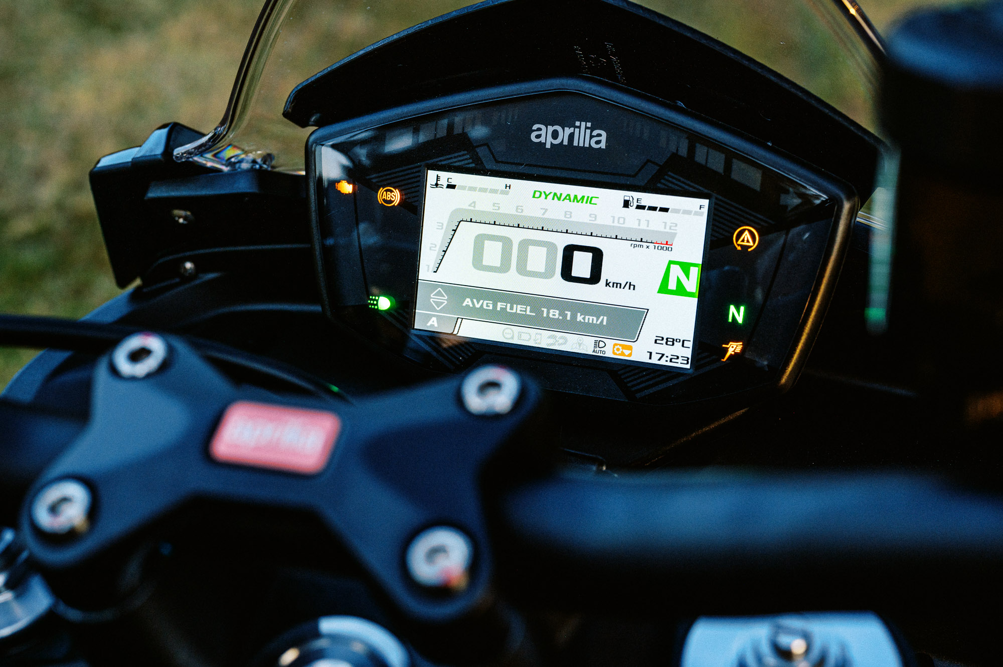 Detail shot of a 2023 Aprilia Tuono 660 Factory in a park at sunset