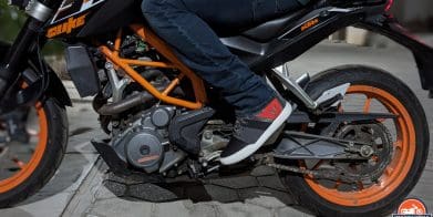 Rider wearing Dainese York Air shoes on a motorcycle.