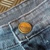 RAVEN logo on the button of the jeans