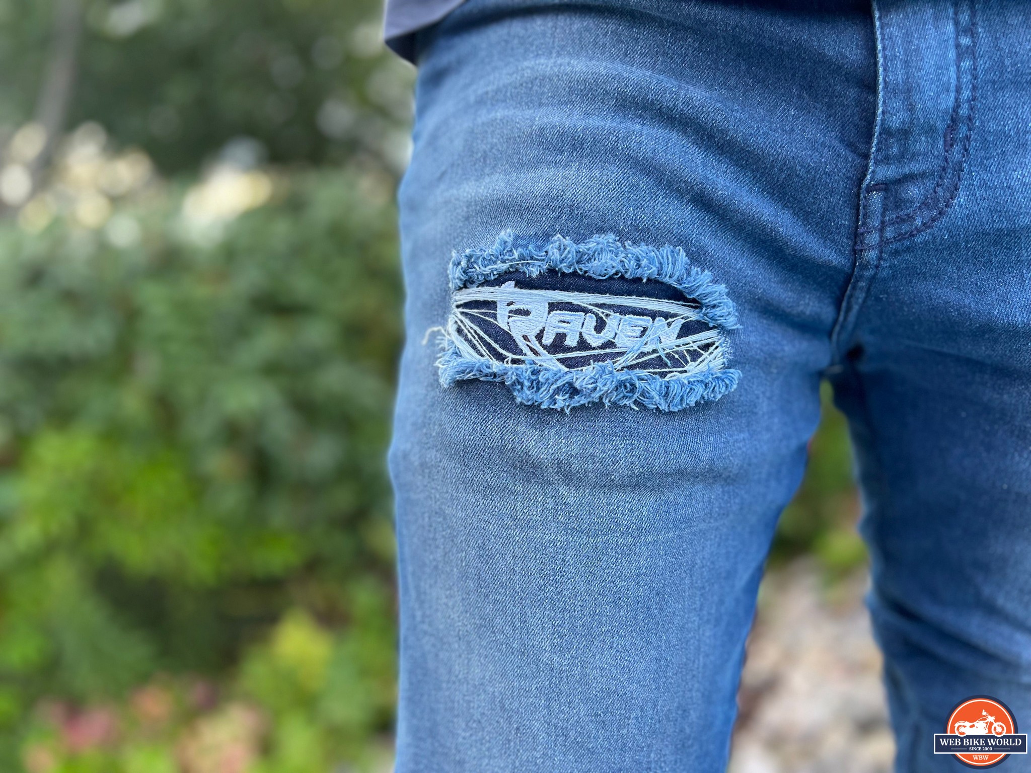 Denim square shape with stitches. Torn jean patch with seam