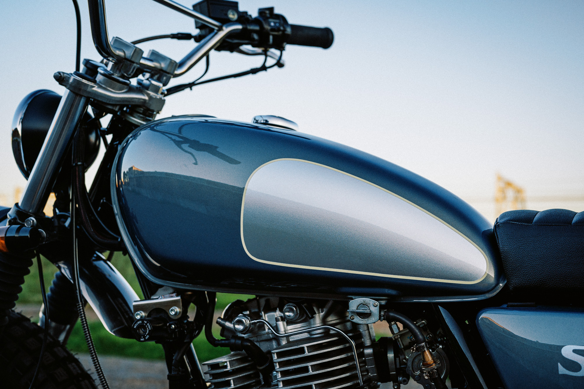 a custom Yamaha SR400 Motorcycle in Sydney at dusk in a vacant lot