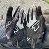 Palm of both the gloves resting on motorcycle seat