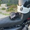 Gloves layered on the bike seats next to rider helmet