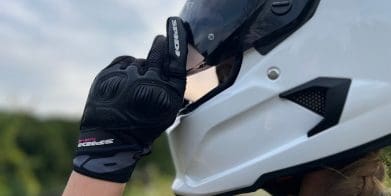 Ashley wearing the Spidi Gloves adjusting helmet