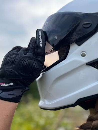 Ashley wearing the Spidi Gloves adjusting helmet