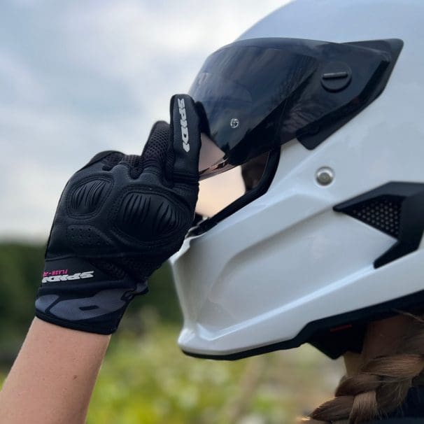 Ashley wearing the Spidi Gloves adjusting helmet