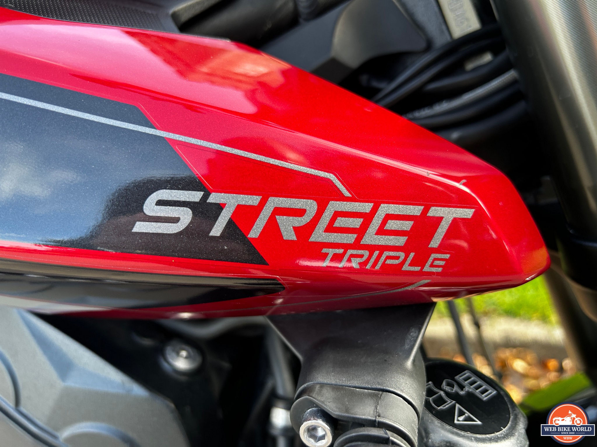 Closeup of the Street Triple logo on the bike