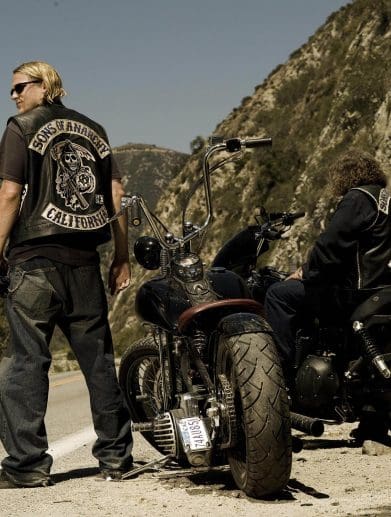 A motorcyclist standing next to two bikes. Media provided by Asphalt & Rubber.