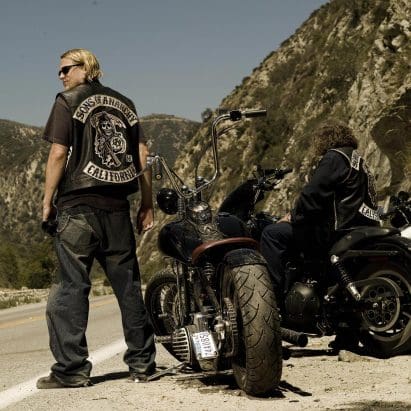 A motorcyclist standing next to two bikes. Media provided by Asphalt & Rubber.