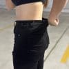 Ashley pulling waistband to show the gap in size