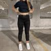 Front view of Ashley wearing the RAVEN High-Waisted REVOLT Ripped Armored Jeans
