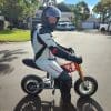 Riding a mini pocket bike while wearing the Sedici Corsa 1 piece race suit