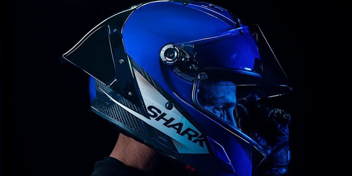 Right side view of a motorcycle racer wearing a helmet.