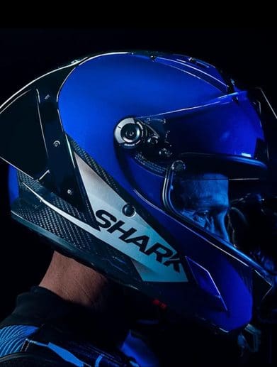 Right side view of a motorcycle racer wearing a helmet.