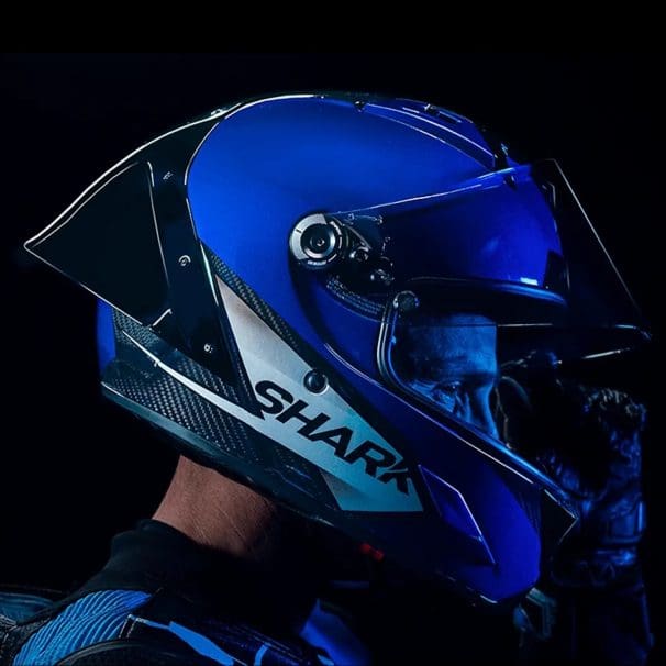 Right side view of a motorcycle racer wearing a helmet.