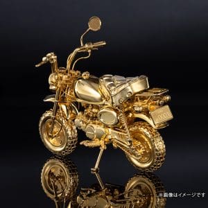 A rear quarter view of a gold motorcycle figurine.
