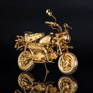 A right side view of a gold motorcycle figurine.