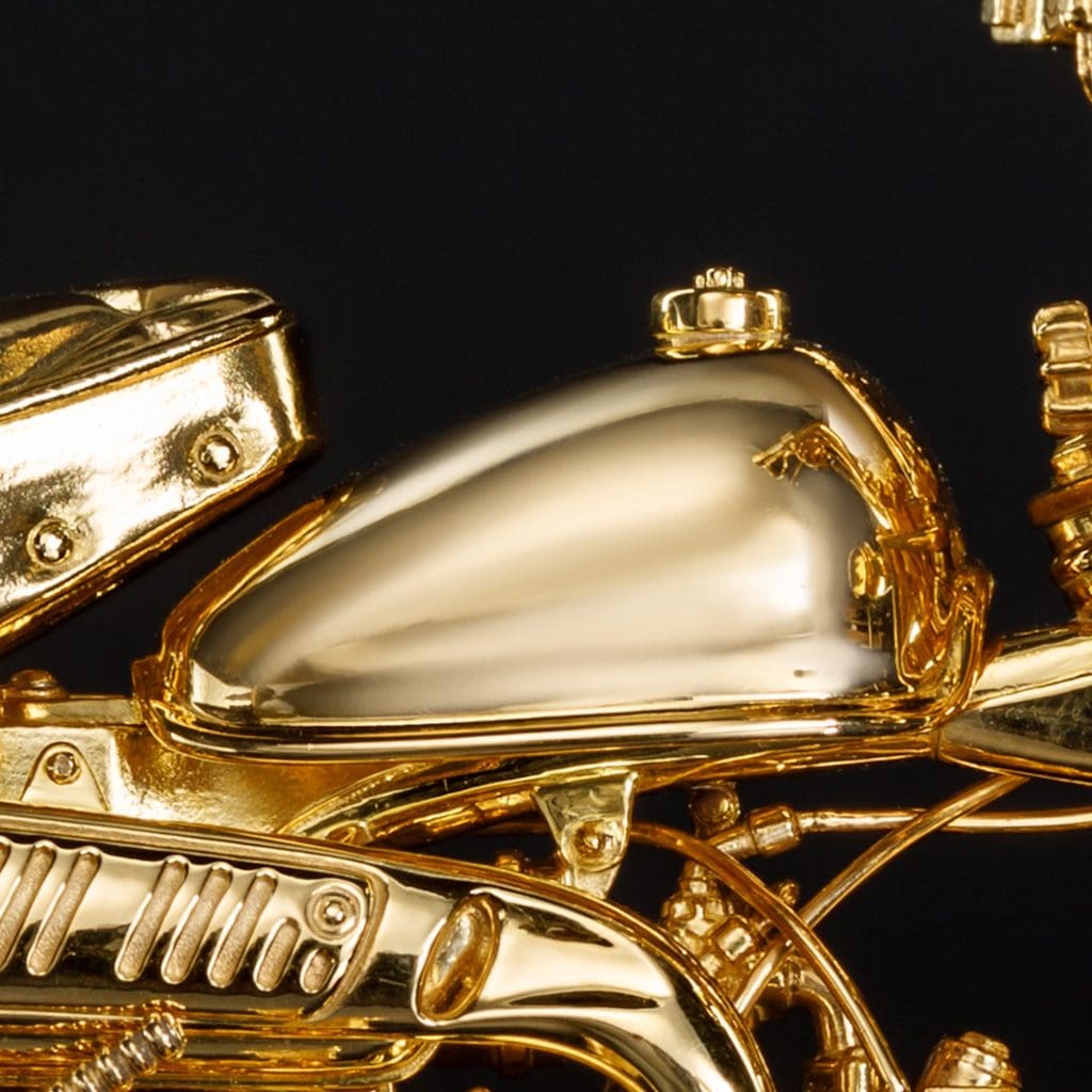 A gold motorcycle figurine's gas tank.