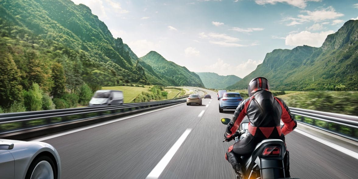 A CGI rendition of a motorcyclist on the road.