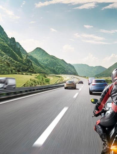 A CGI rendition of a motorcyclist on the road.