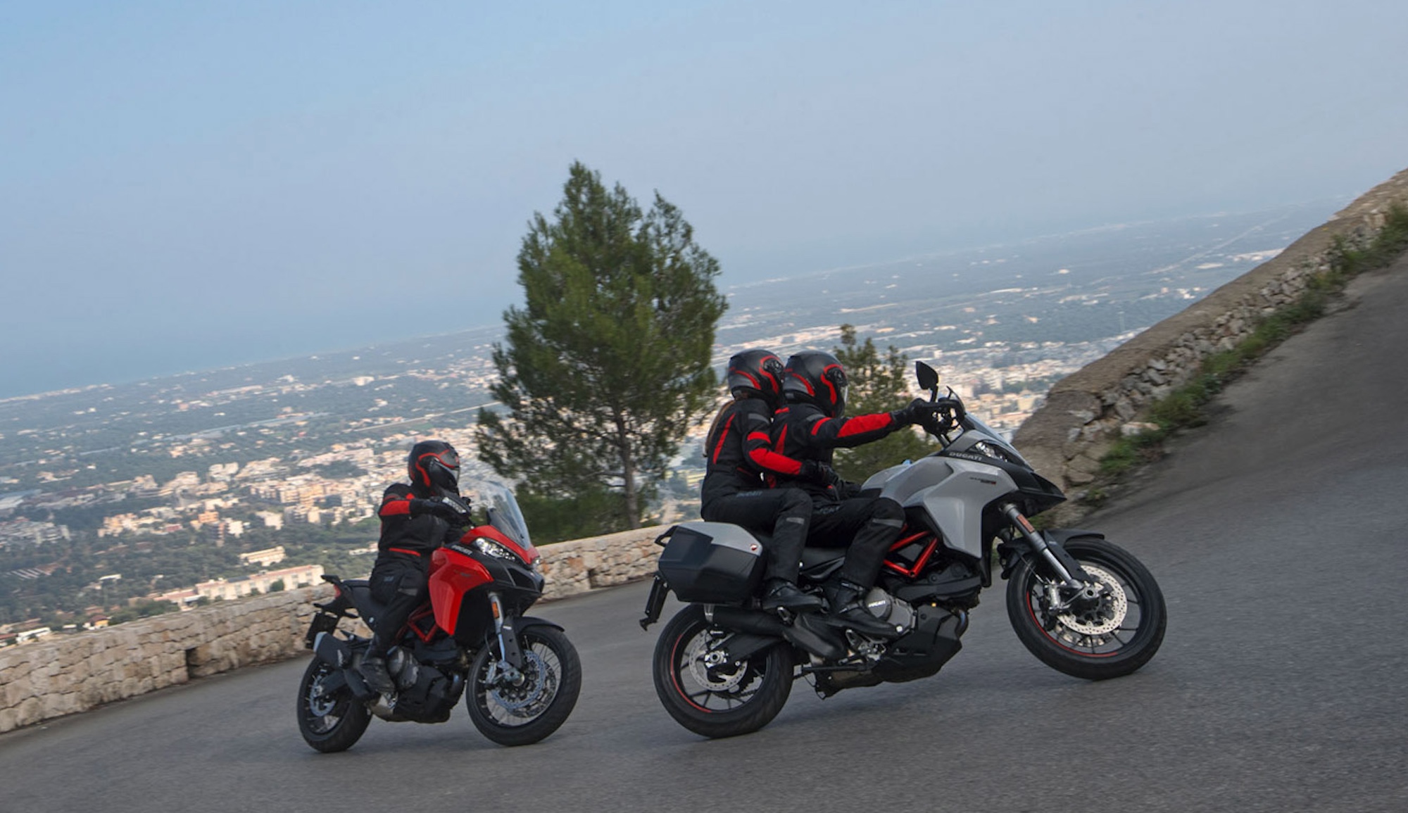Two motorcyclists on Ducati motorcycles.
