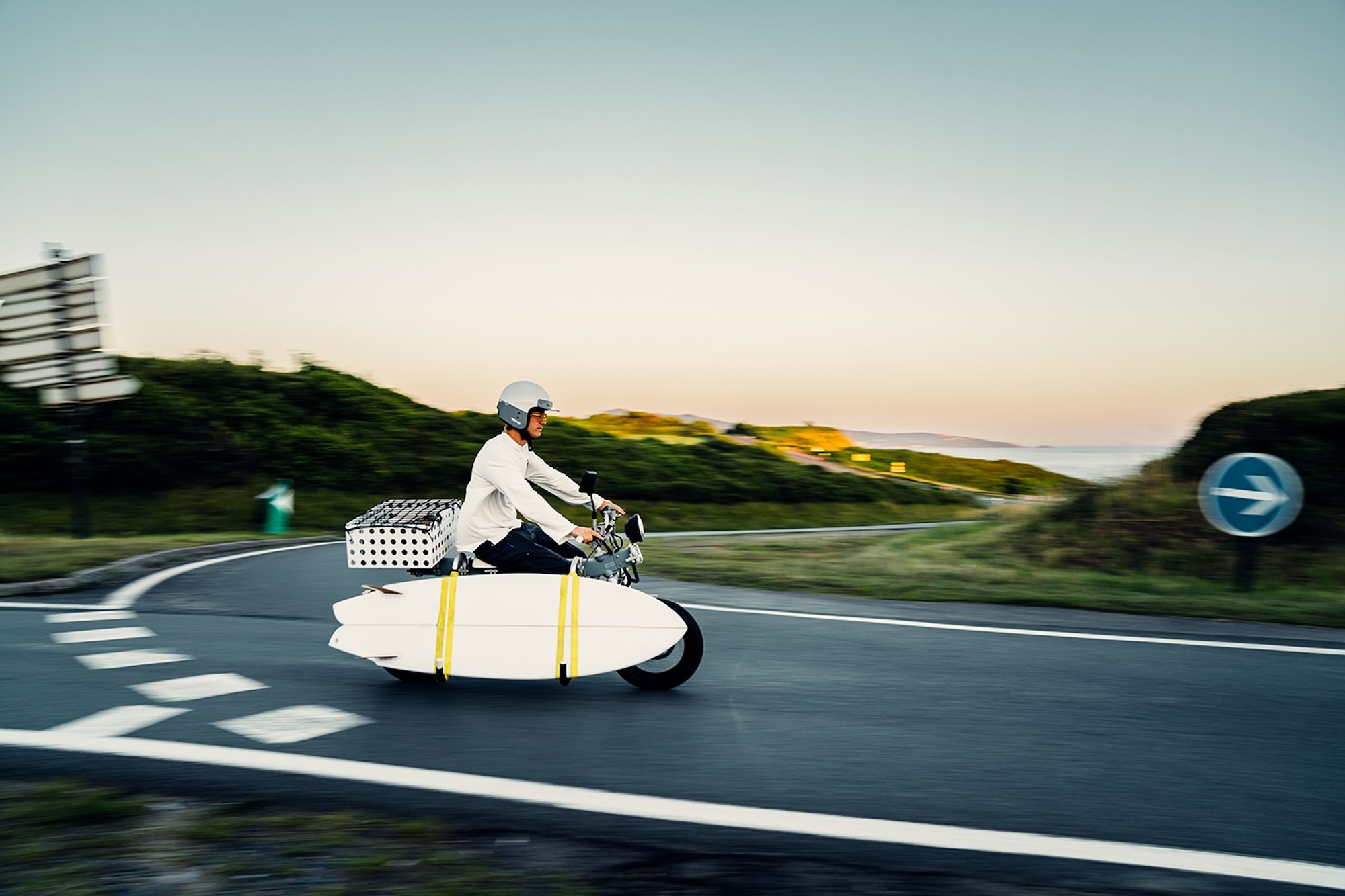 A motorcyclist riding a CAKE Ösa Flex in the country.