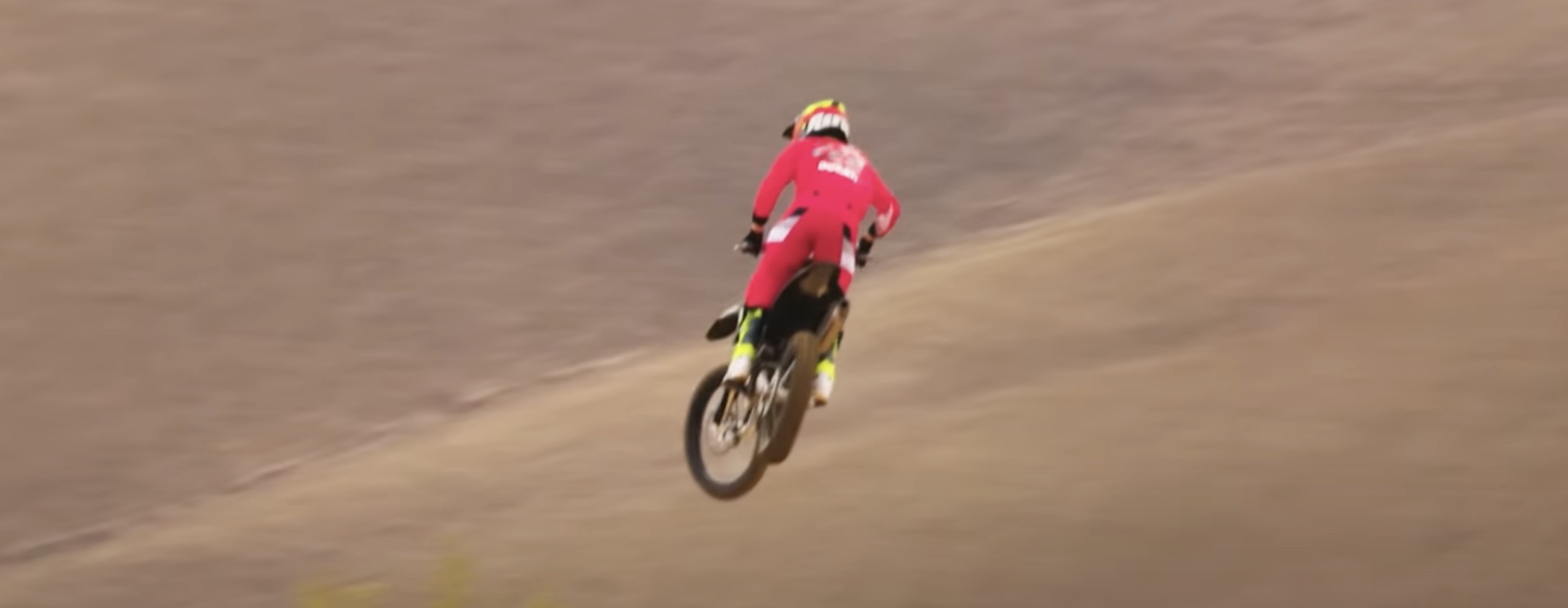 A rear view of a Ducati motocross motorcycle in the air.