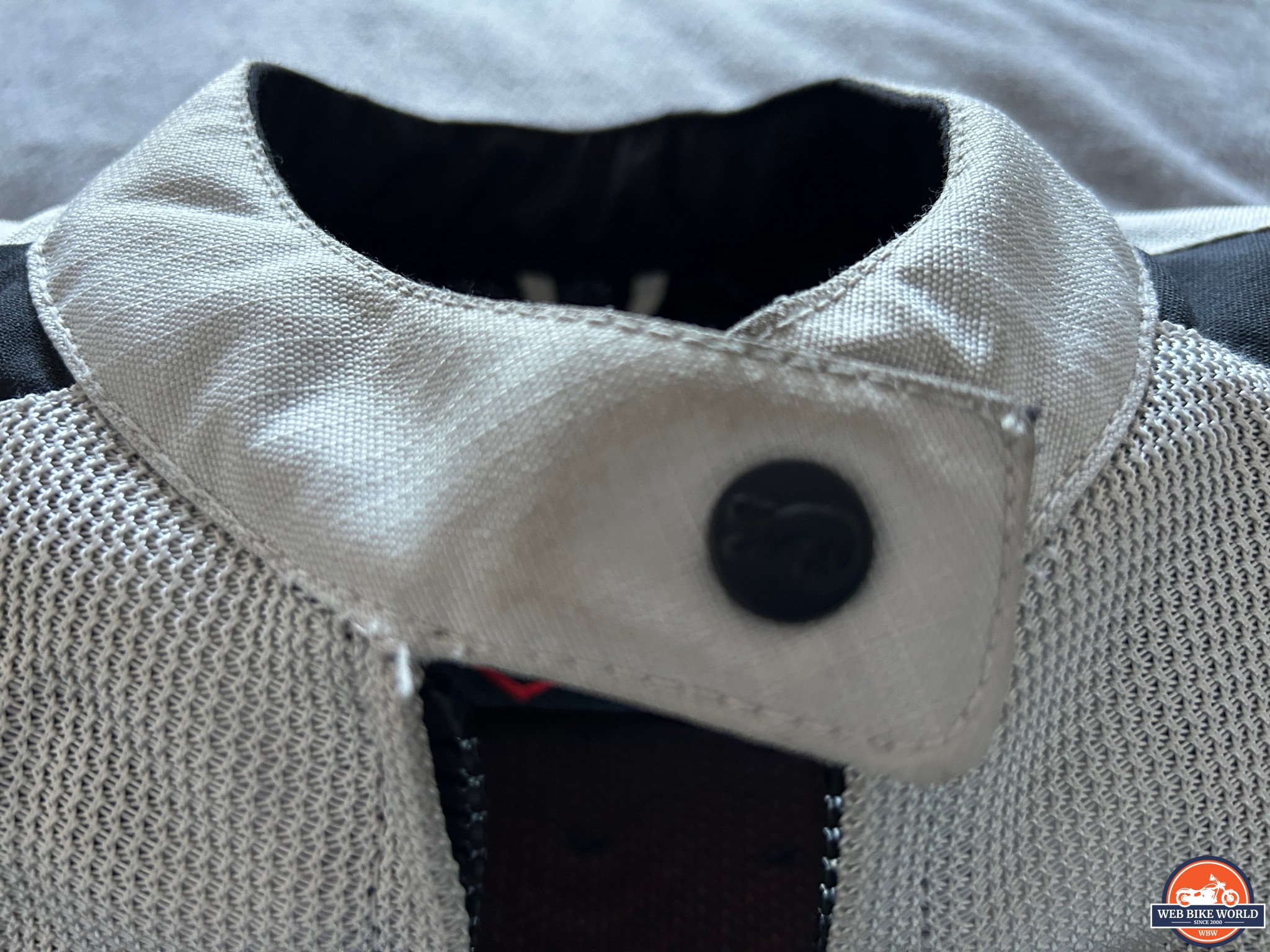 Closeup of the single popper fastener on the Furygan Odessa Jacket