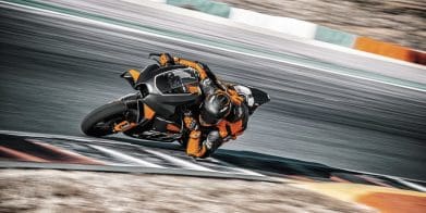 A rider on a track-focused KTM motorcycle.