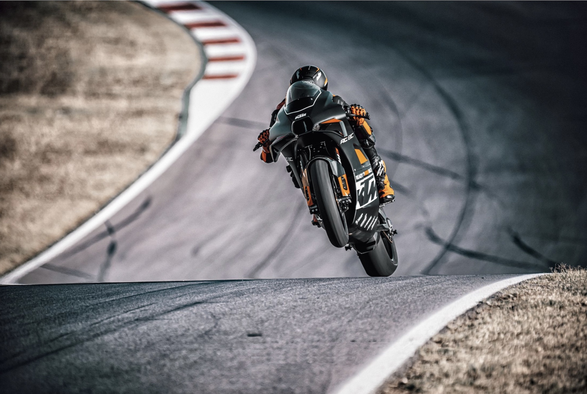 A rider on a track-focused KTM motorcycle.