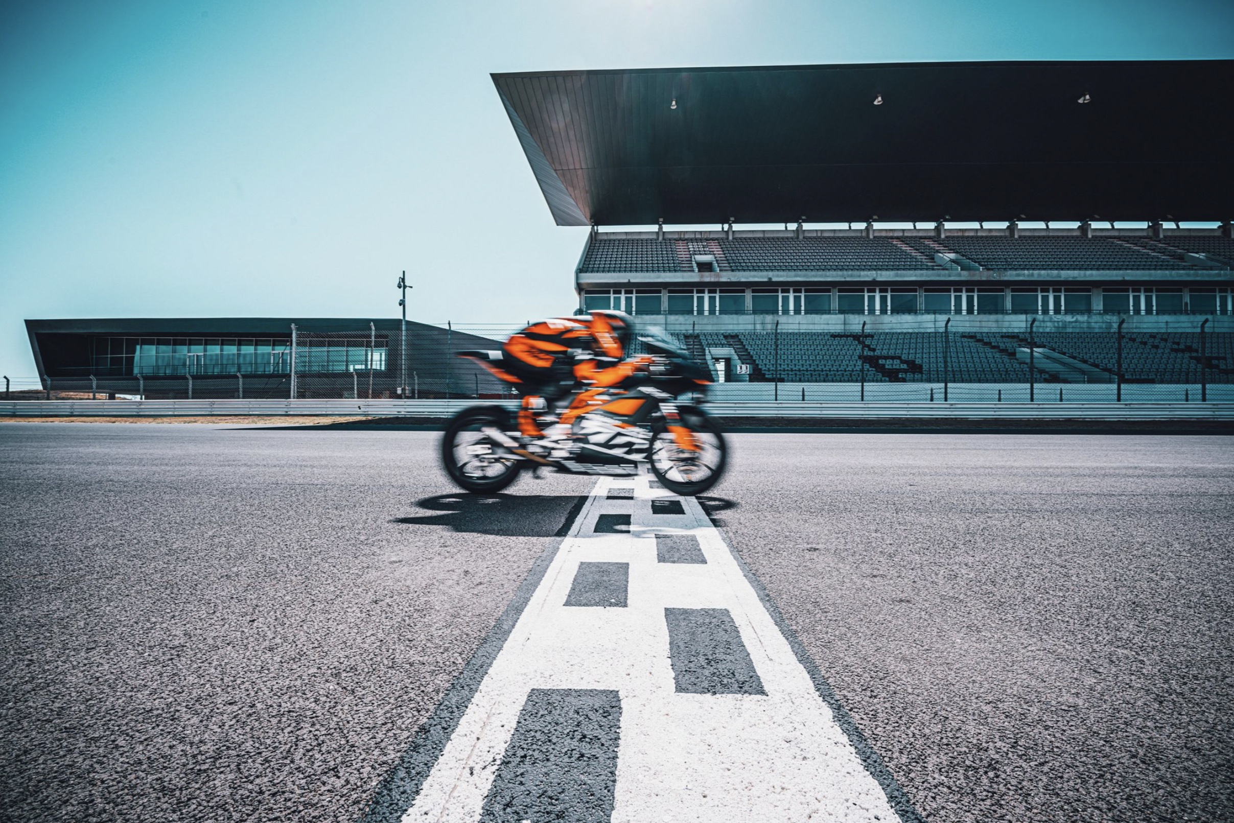 A rider on a track-focused KTM motorcycle.