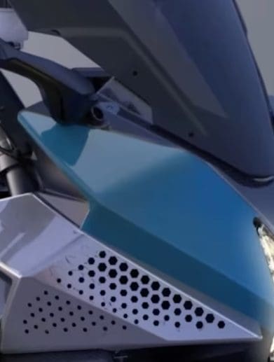 A close-up of the front headlight of a Kawasaki H2 HySE motorcycle.