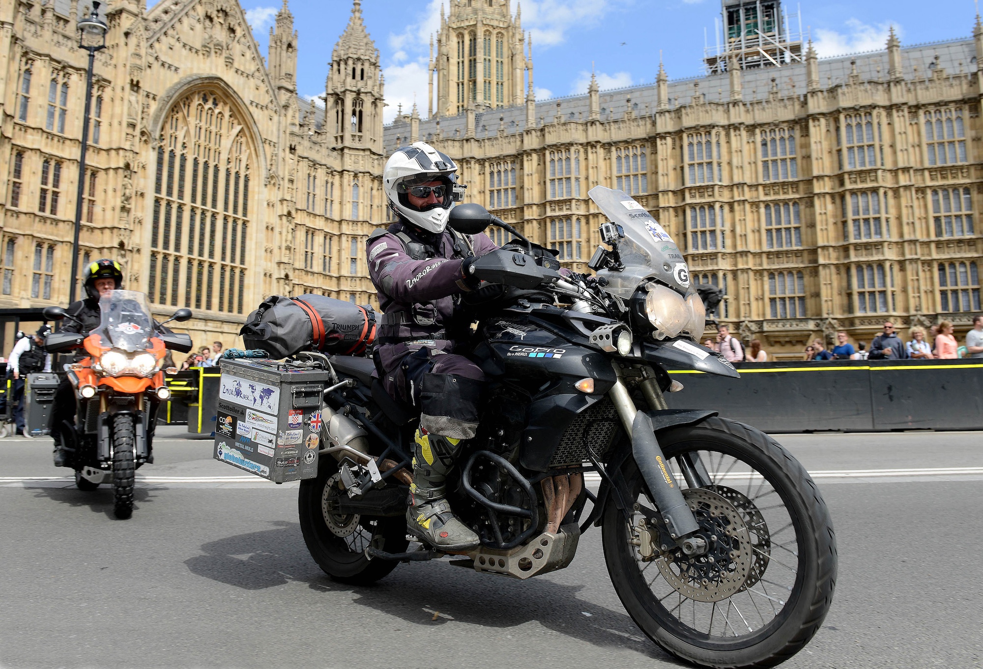 A motorcyclist in front of the Parliament building.