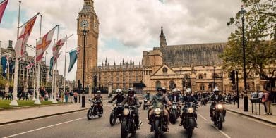 a group of motorcyclists in front of the London Parliament building.