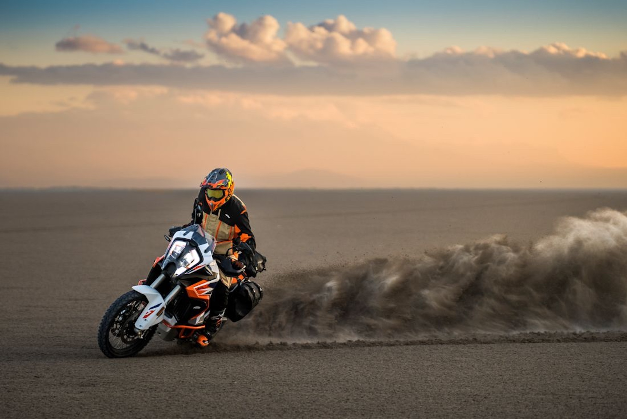 KTM's 2023 1290 Super Adventure R motorcycle drifting in a desert.