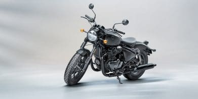 A side quarter view of a Royal Enfield motorcycle in a studio setting.