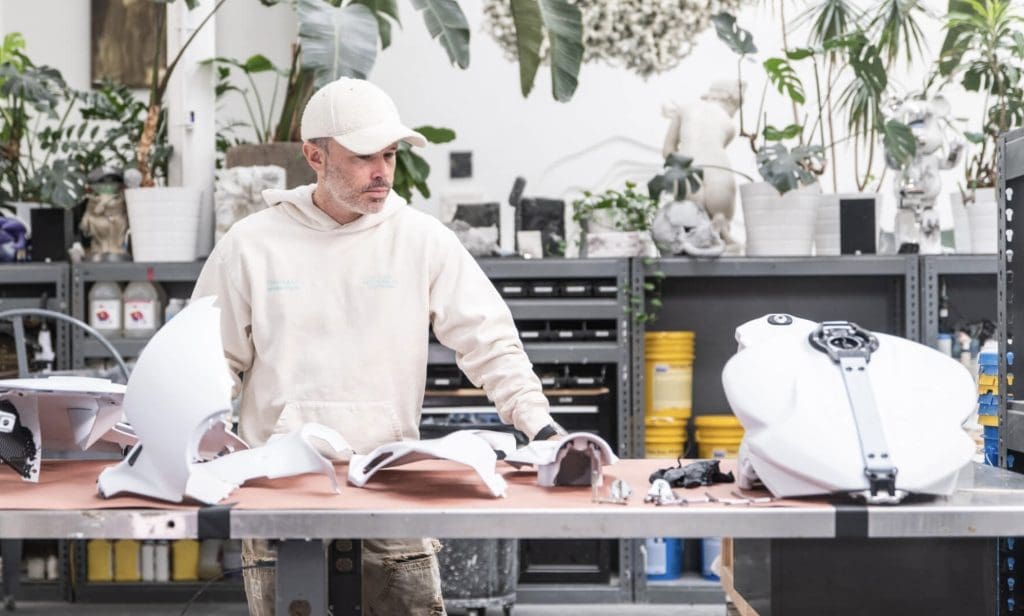 Daniel Arsham behind parts to his Superveloce Arsham motorcycle.