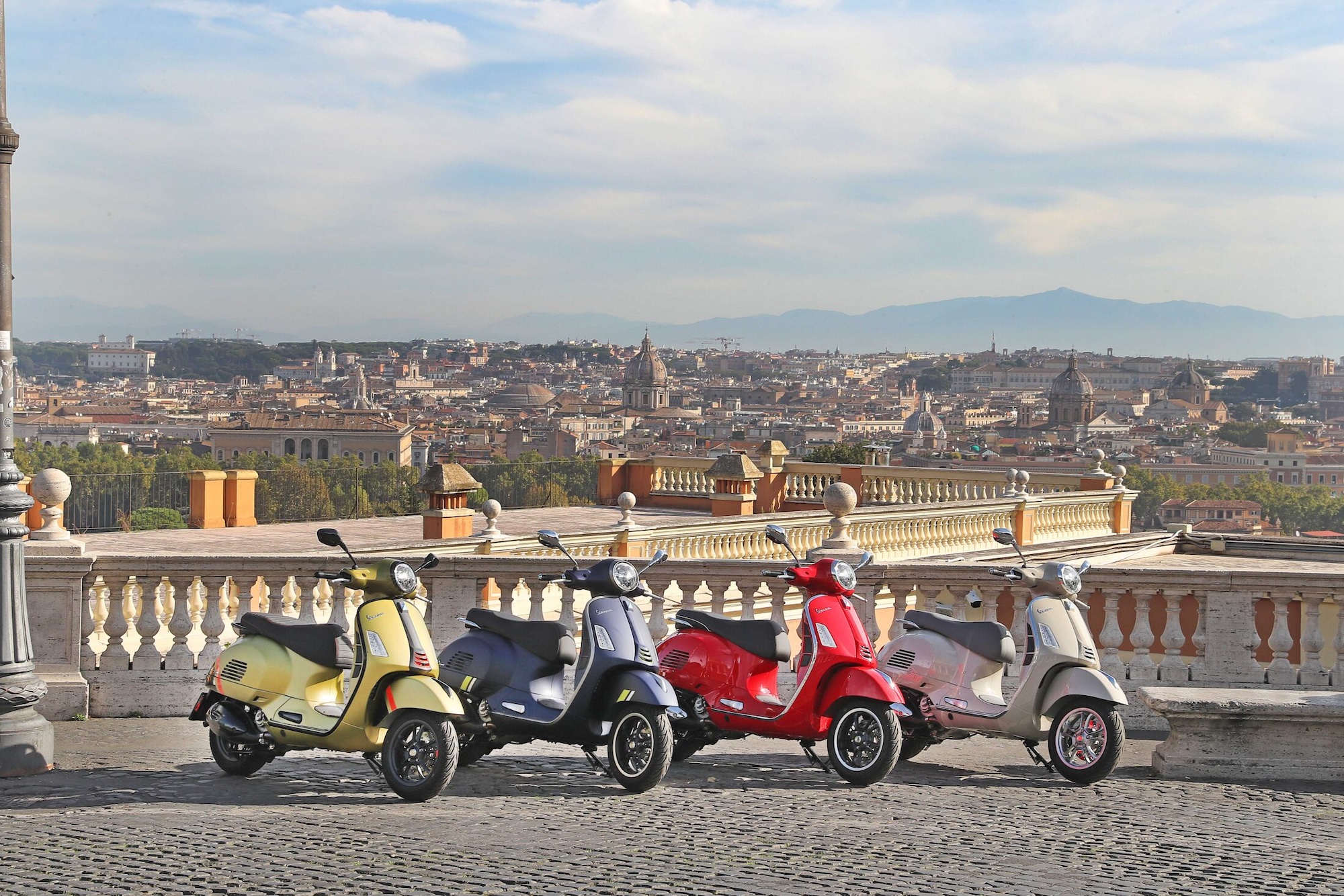 Four Vespa scooters.