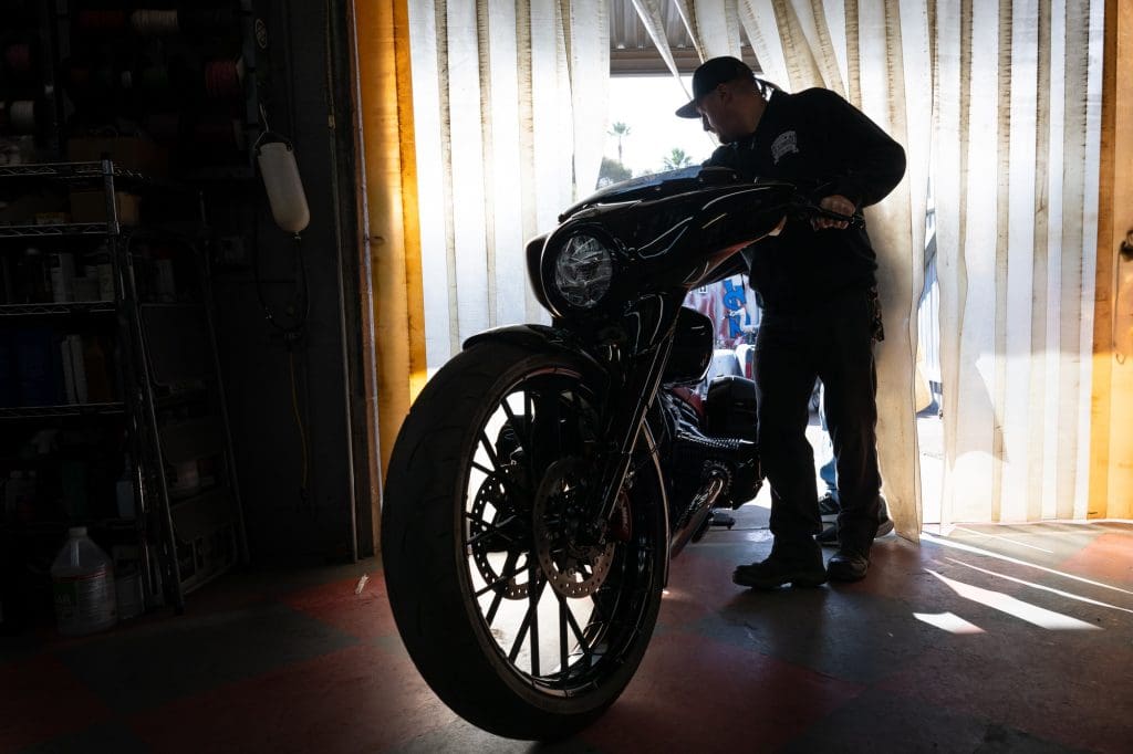 A silhouette of a hot rod motorcycle and rider.