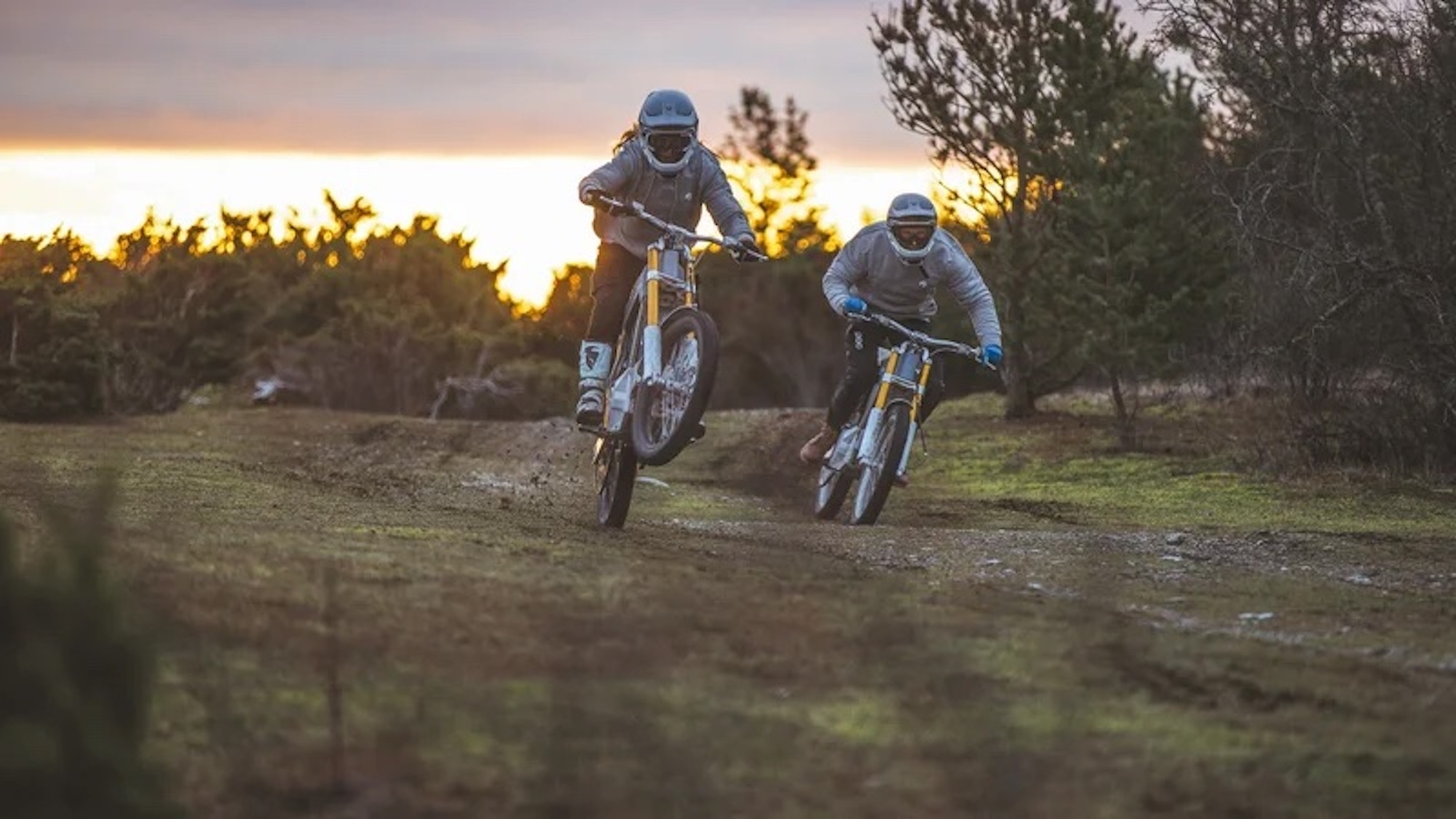 Two motorcyclists on electric motorcycles.