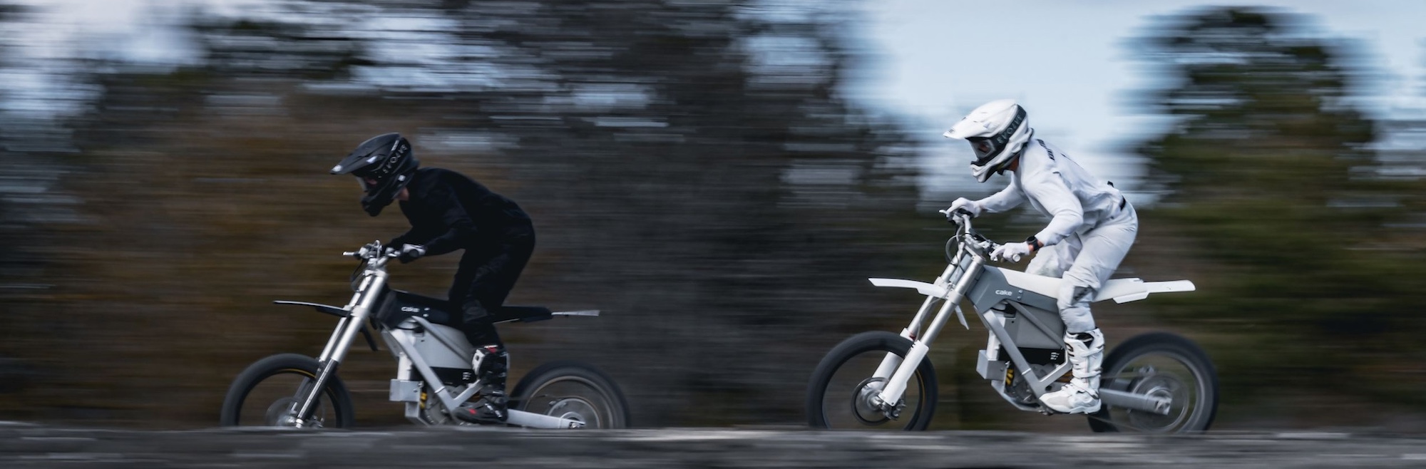 Two motorcyclists on electric motorcycles.