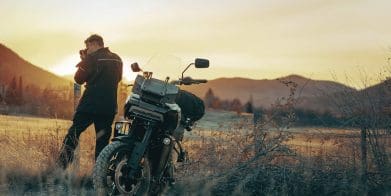 A motorcyclist getting ready to ride a Harley motorcycle.