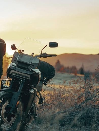 A motorcyclist getting ready to ride a Harley motorcycle.