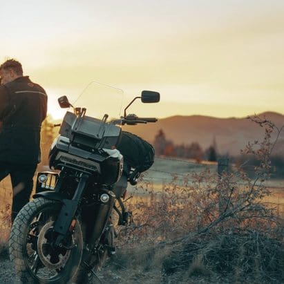 A motorcyclist getting ready to ride a Harley motorcycle.