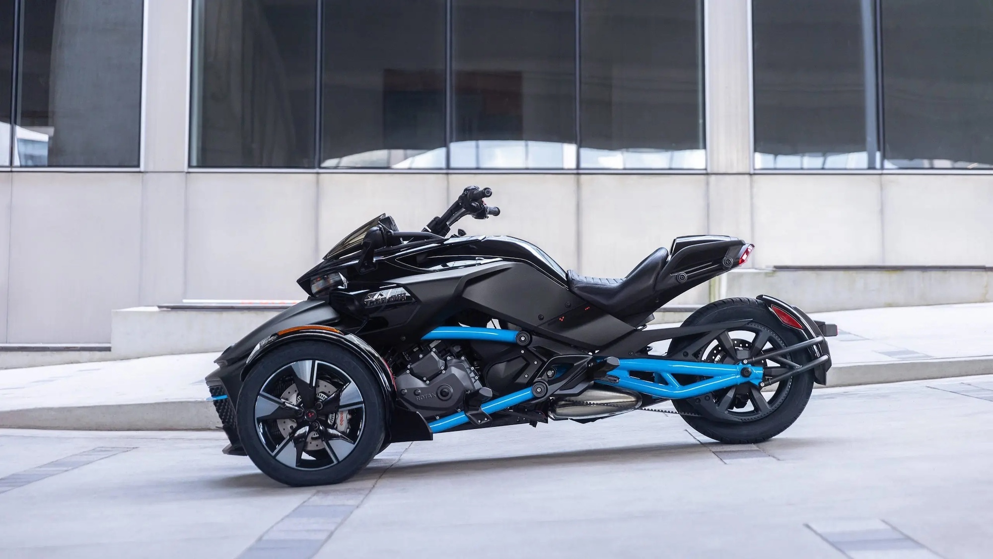 A three-wheeled motorcycle in the city.